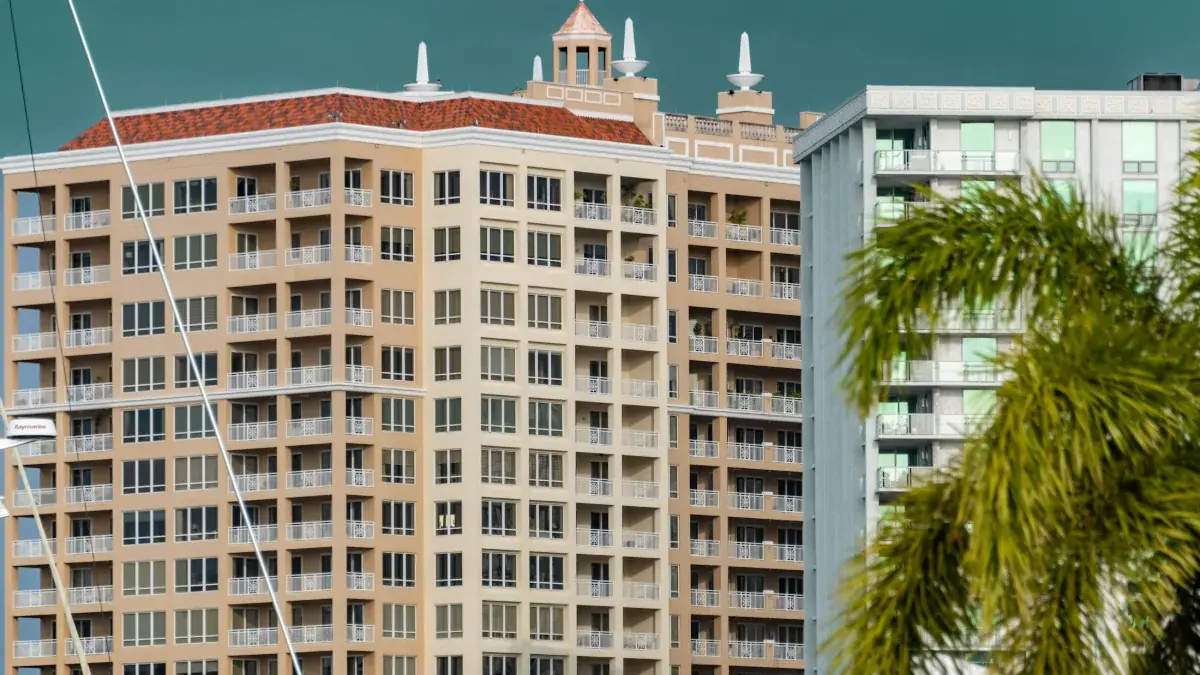 High-rise condominium building beside a palm tree in Florida