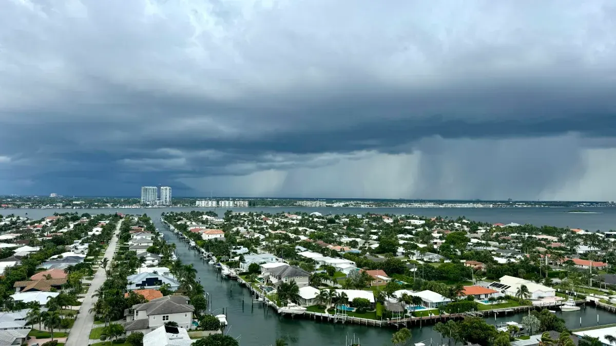 Storm clouds gathering over a coastal Florida neighborhood and waterway